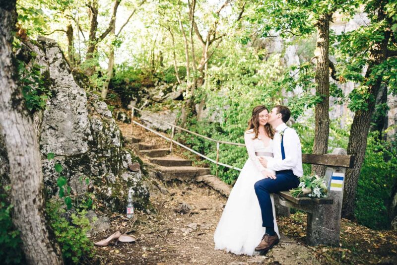 couple-sitting-on-bench-wedding-portrait