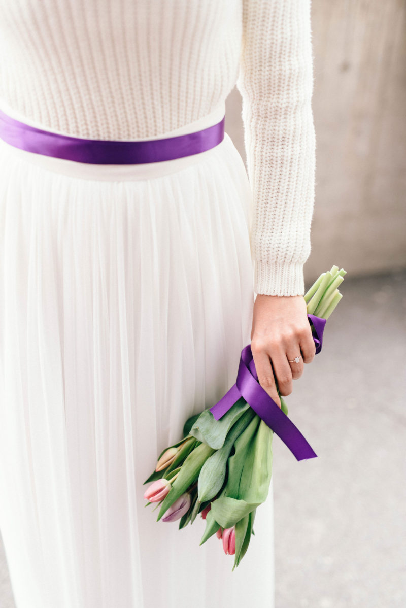 holding a tulip in one hand purple