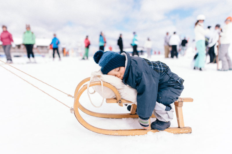 kid sleeping on sledge