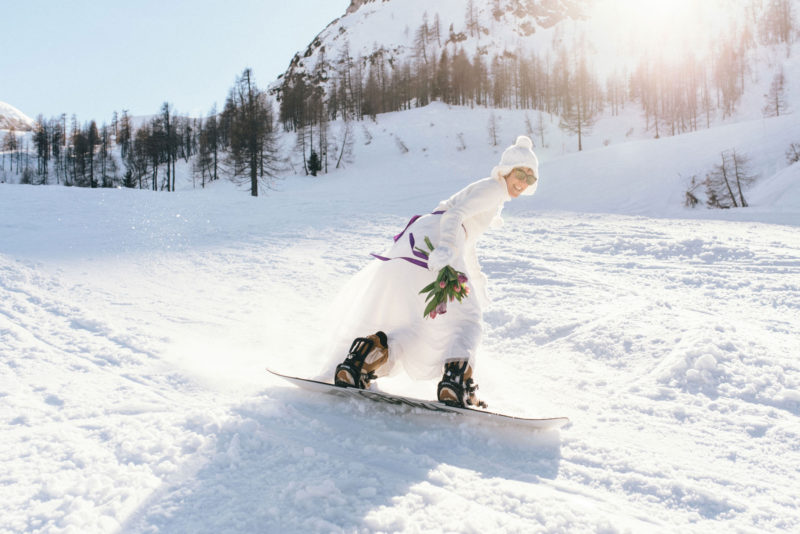 bride airing with a snowboard