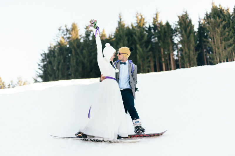 bride and groom in sunset walking in snow