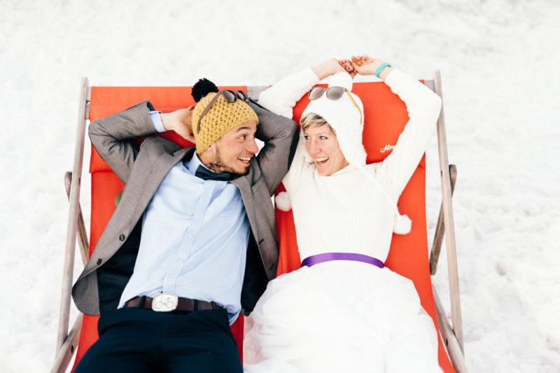 bride and groom in sunset walking in snow