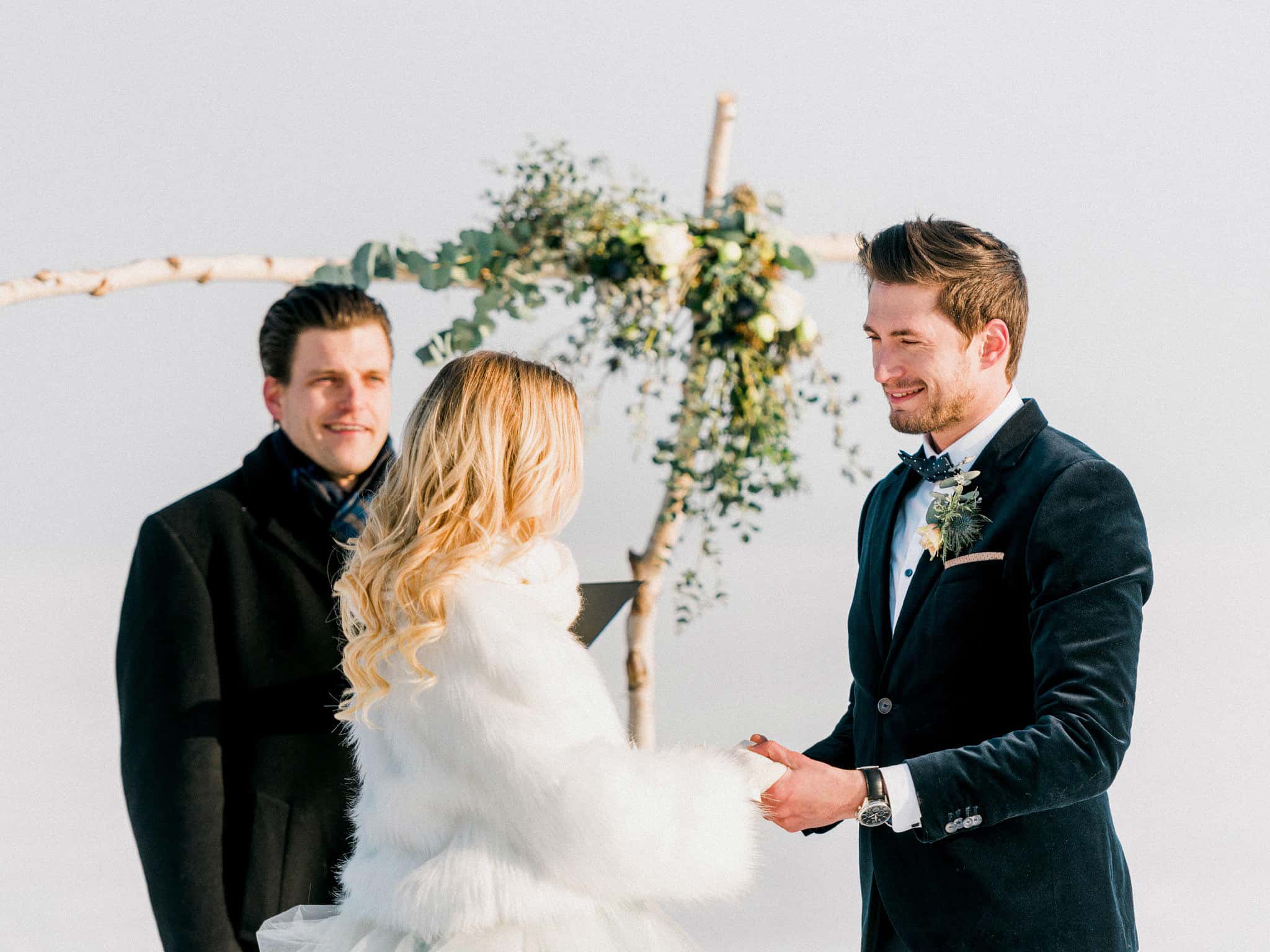 20_wedoverhills_elopement_holding_hand_wearing_bolero