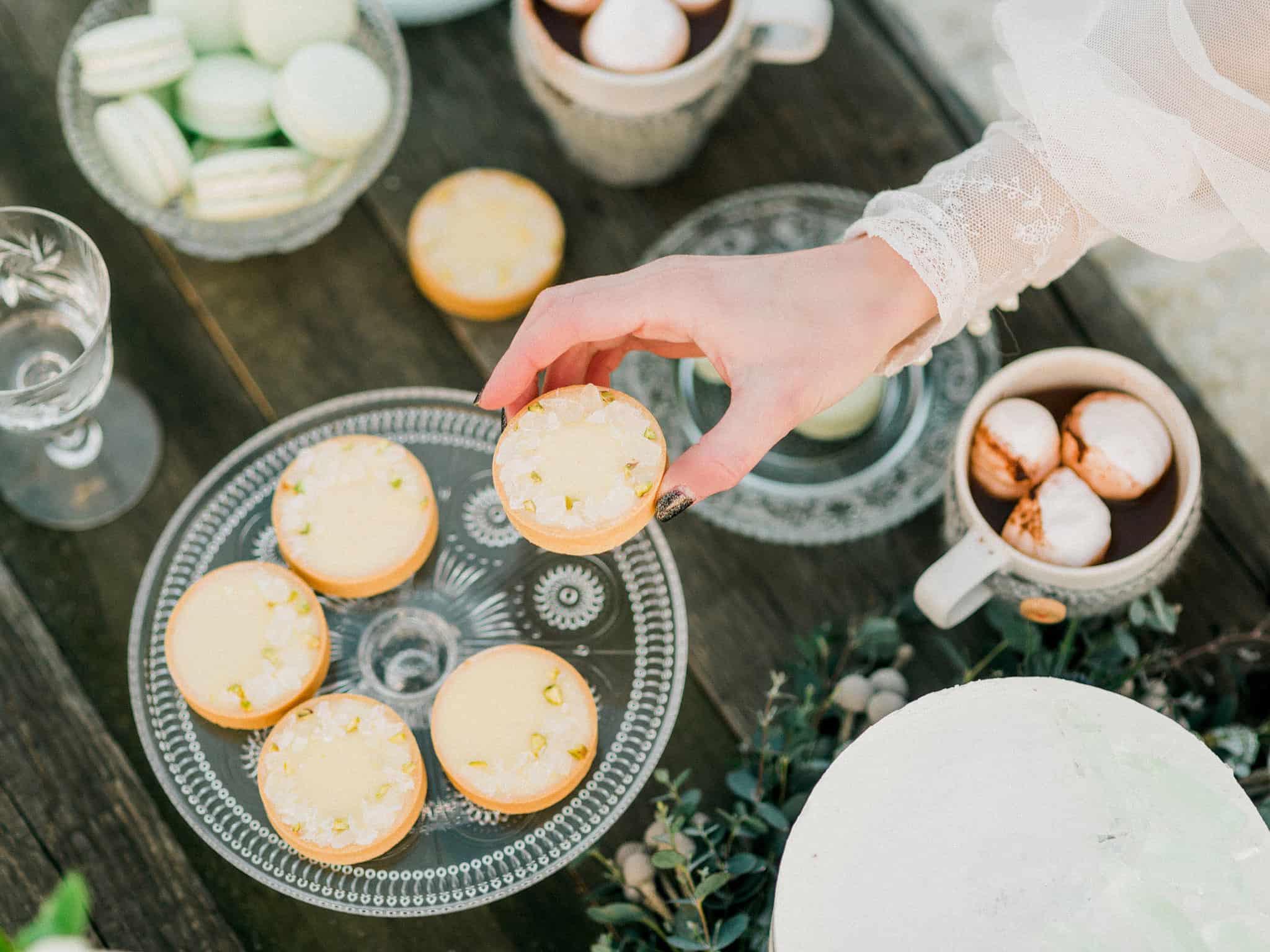 57_wedoverhills_elopement_bride_reaching_for_small_cake